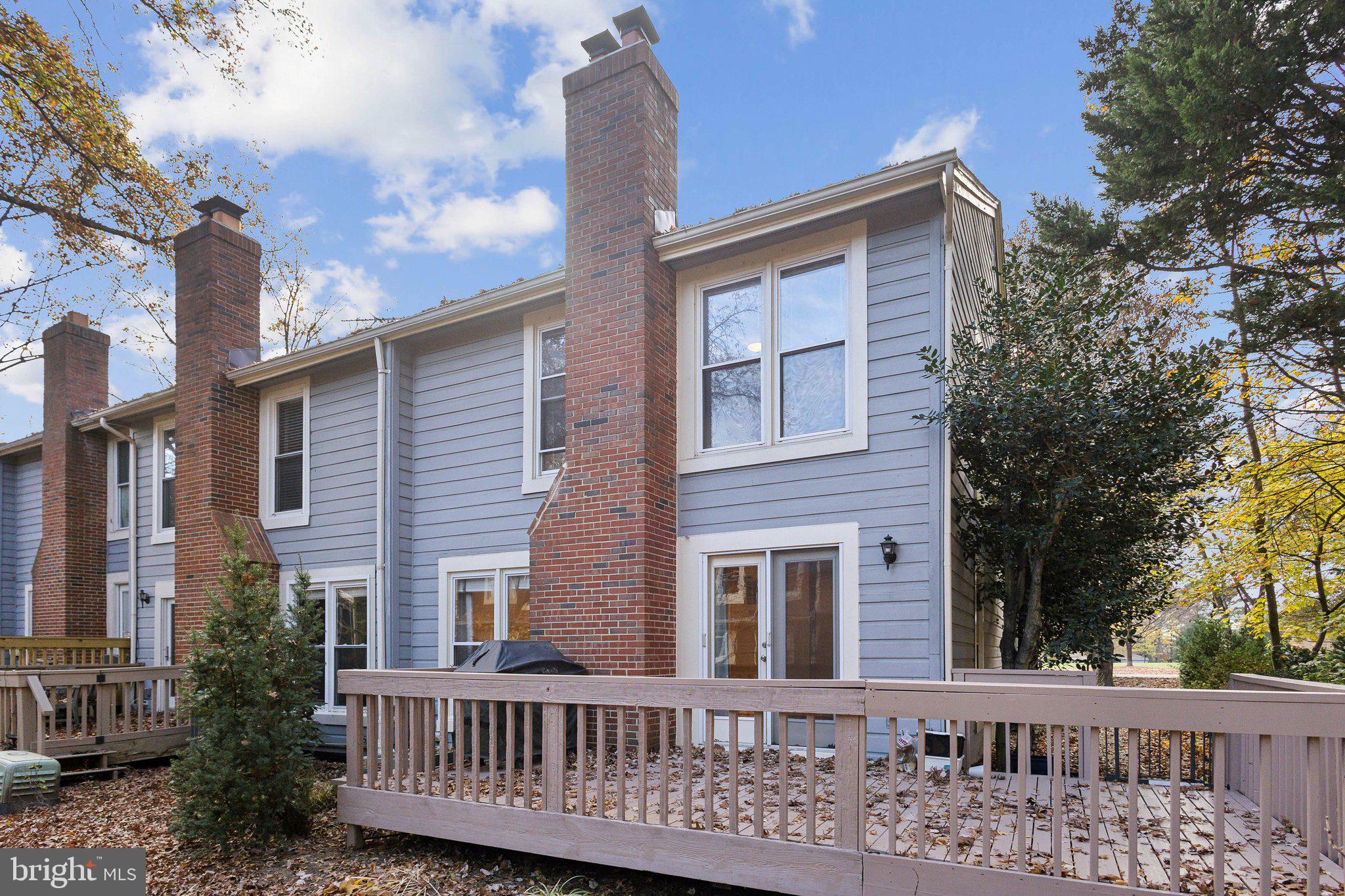 a view of a brick house with a small yard