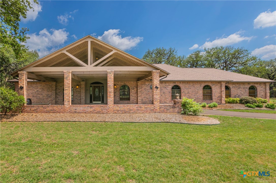 a front view of a house with yard and porch