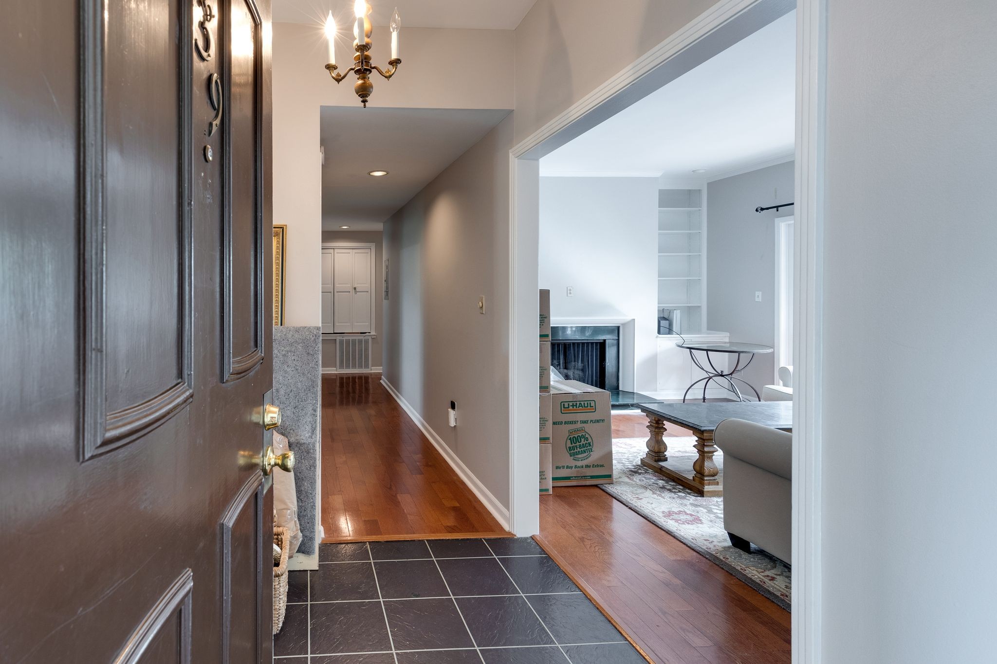 a view of a hallway with wooden floor and staircase