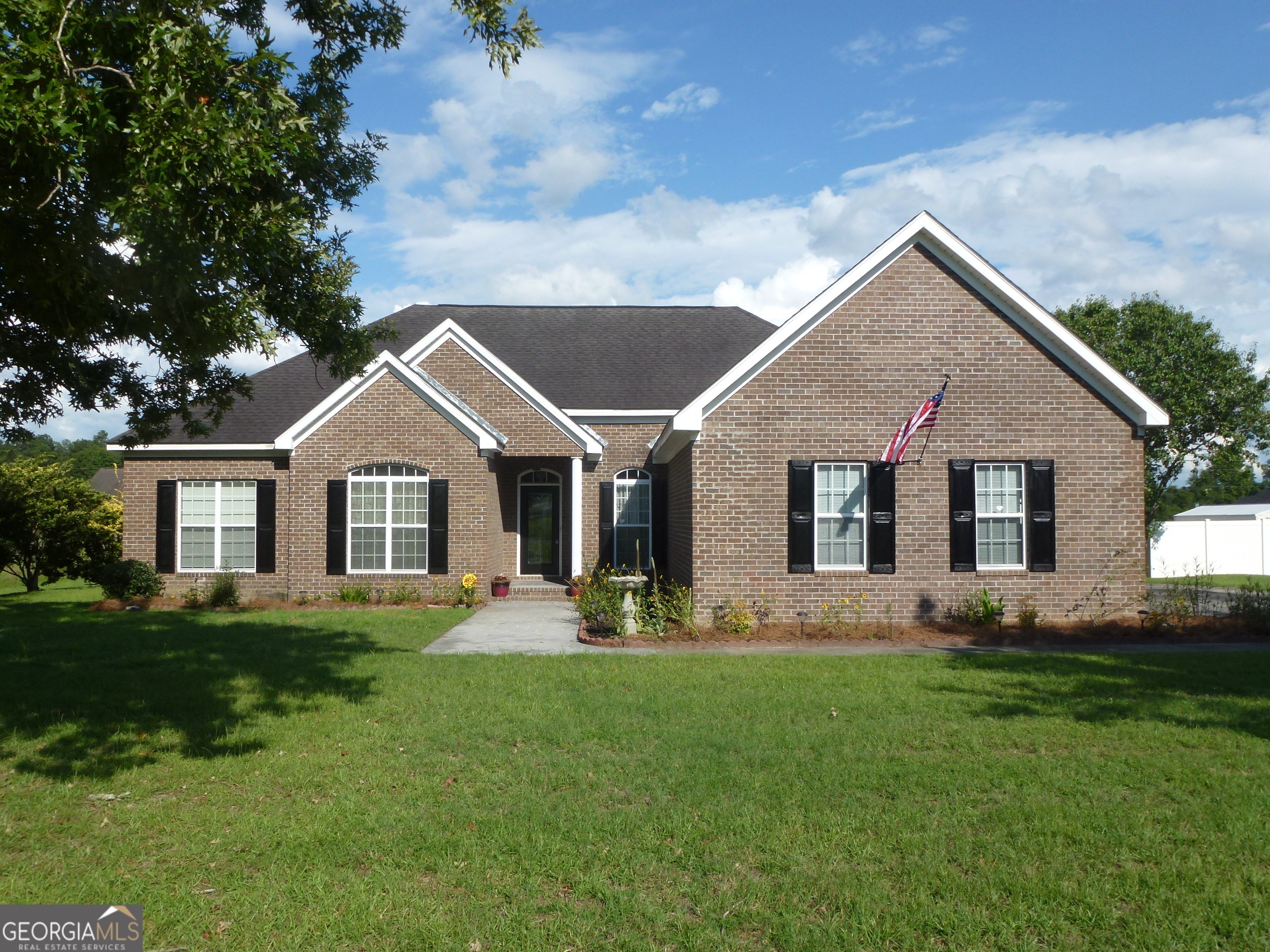 a front view of house with yard and green space