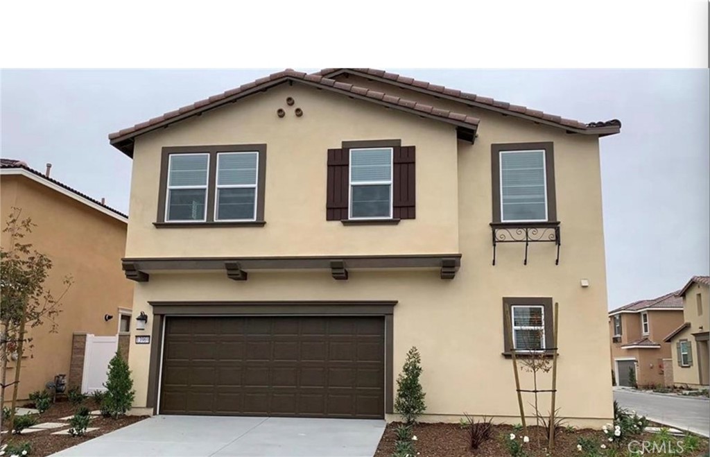 a front view of a house with parking