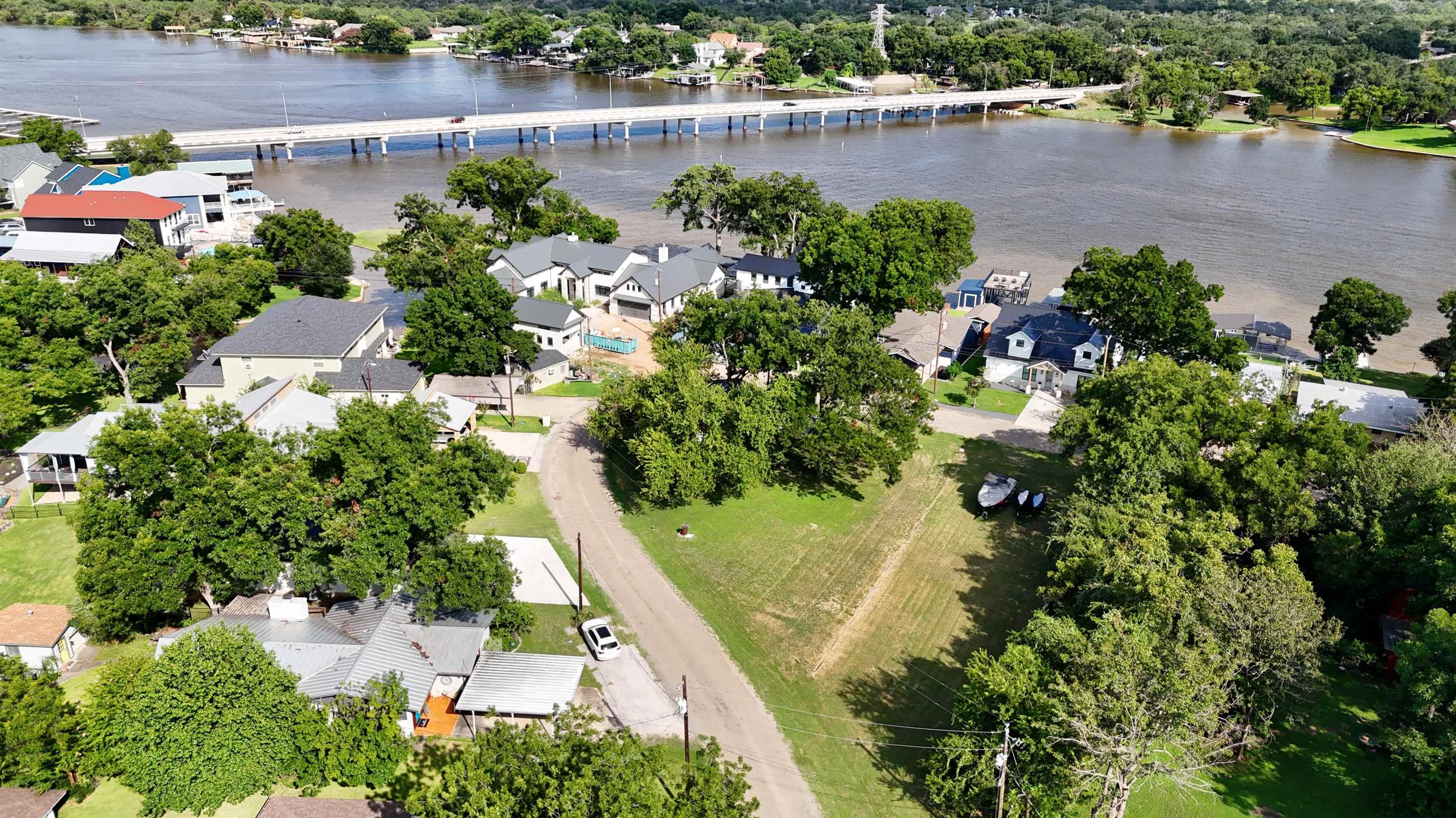 an aerial view of a house with a yard and lake view