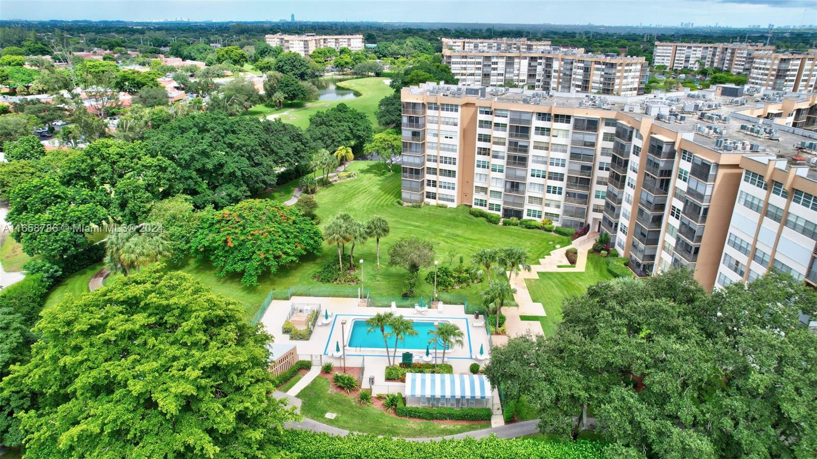 a view of a multi story building with a yard