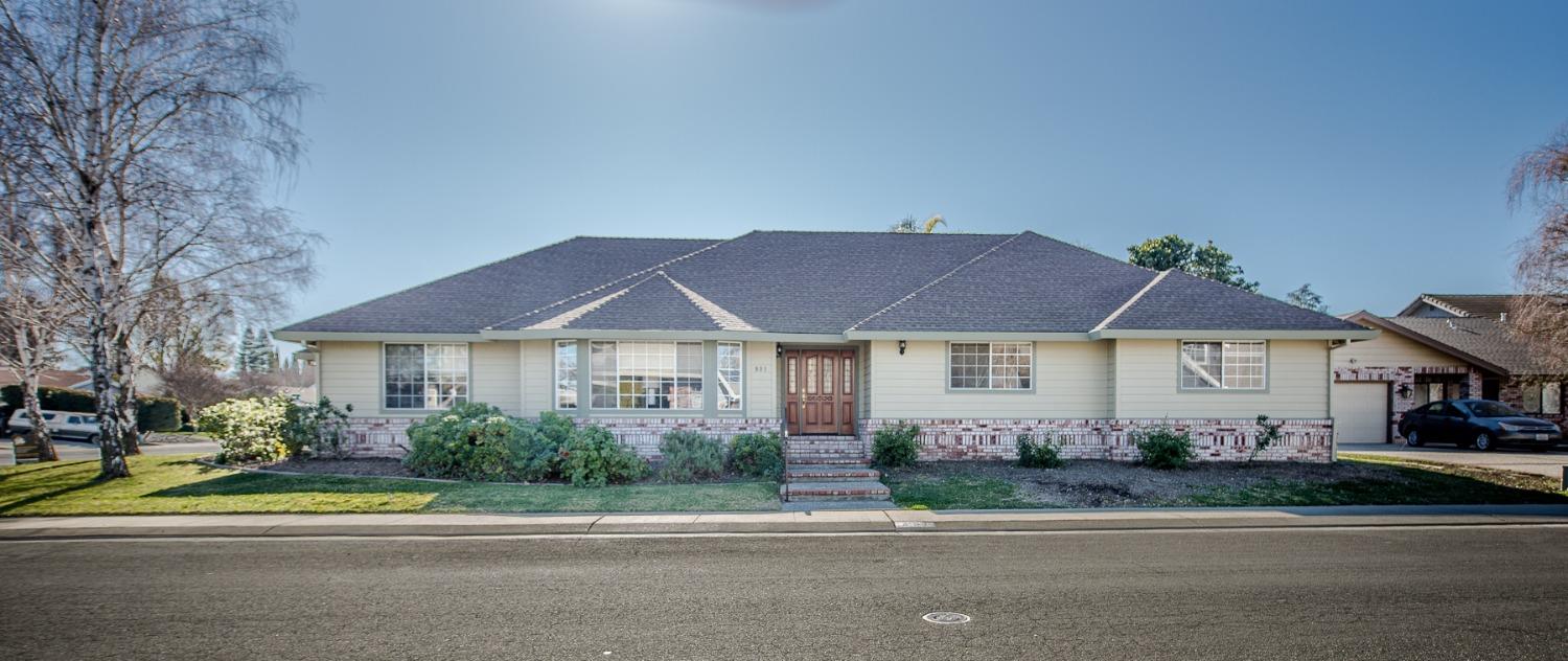 a front view of a house with a yard and plants