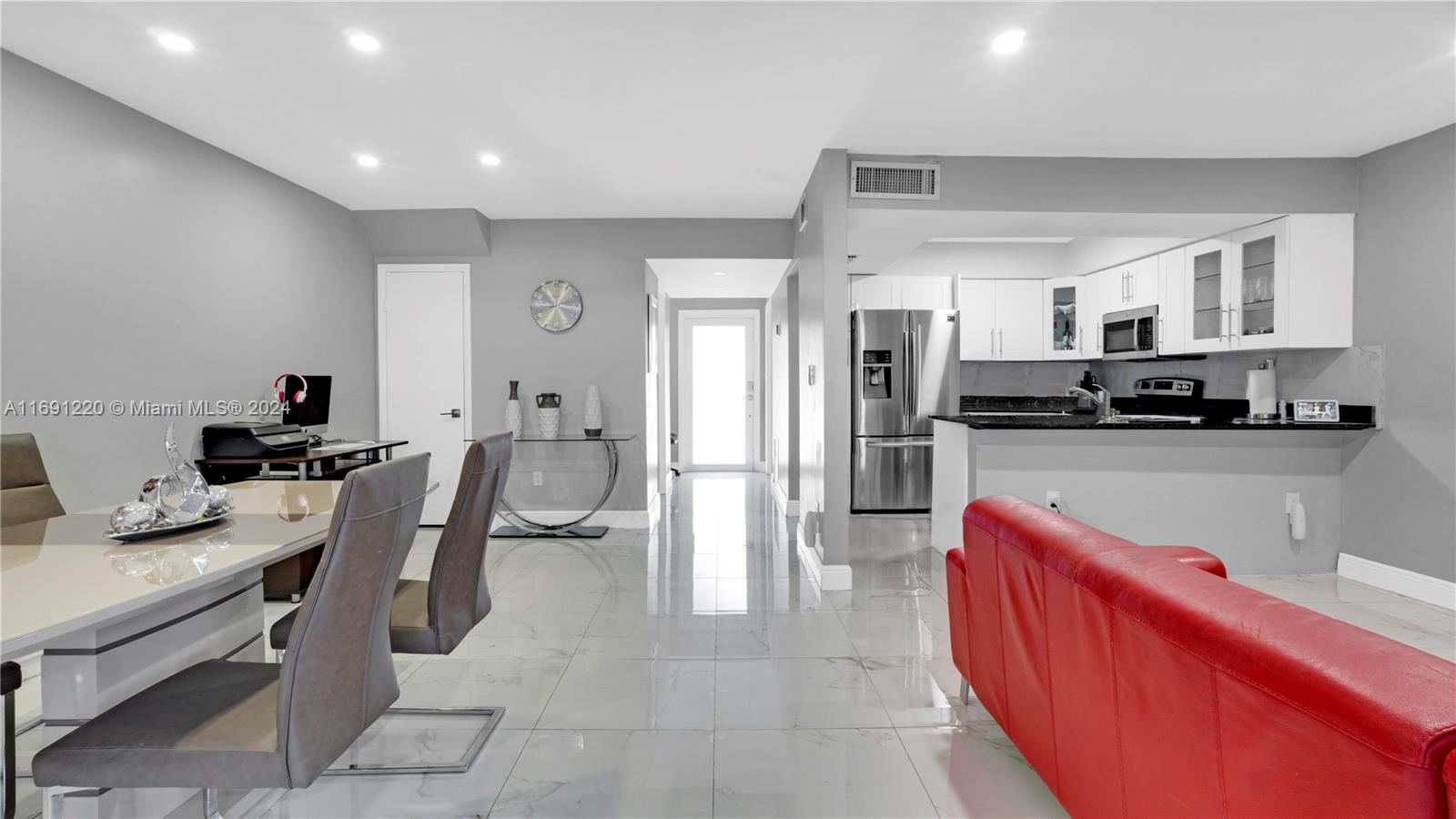 a kitchen with stainless steel appliances kitchen island granite countertop a sink and cabinets