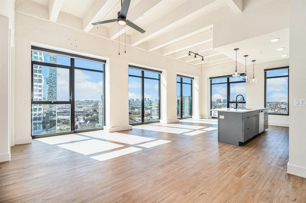 a view of an empty room and window with wooden floor