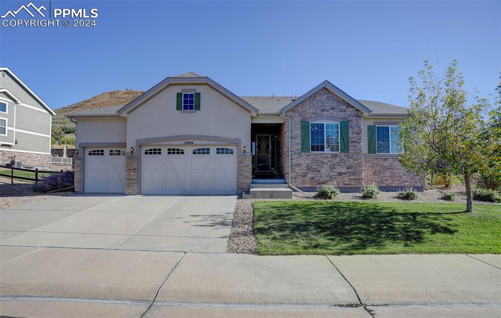 a front view of a house with a yard and garage