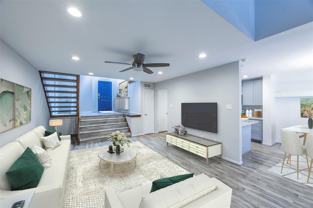 a living room with furniture and wooden floor