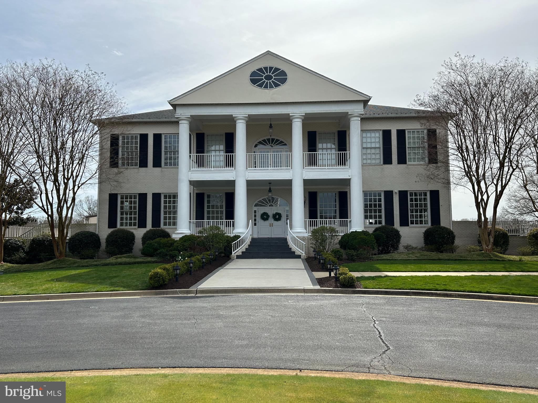 a front view of a brick house with a yard