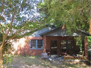 a view of a house that has a tree in it