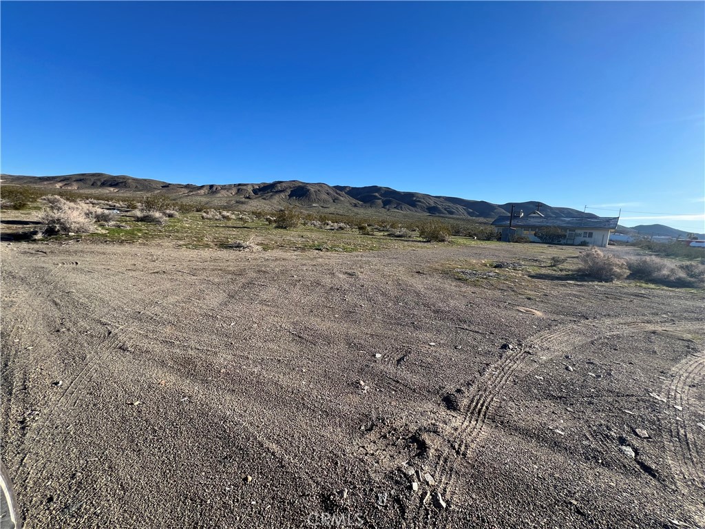 a view of an ocean beach and mountain