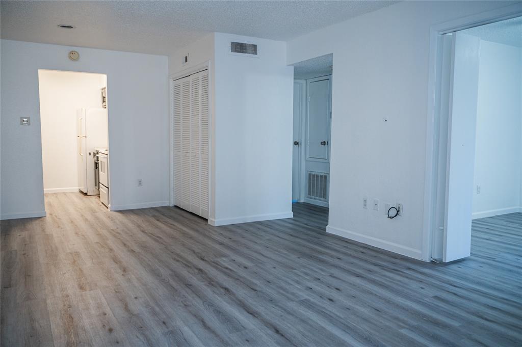 an empty room with wooden floor