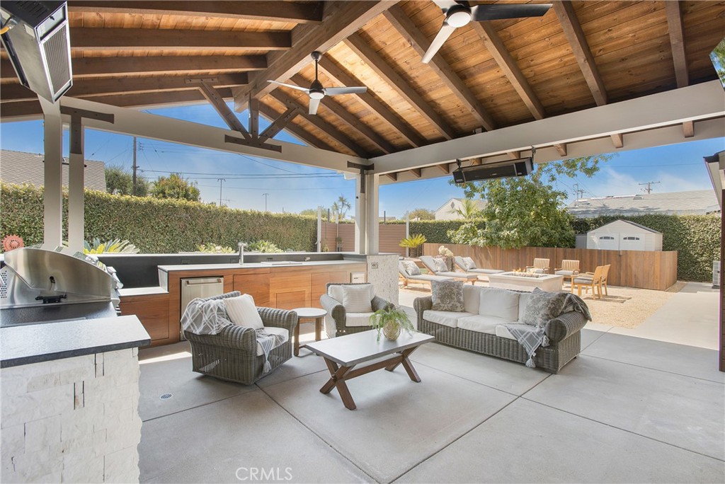 a balcony with furniture and a ceiling fan