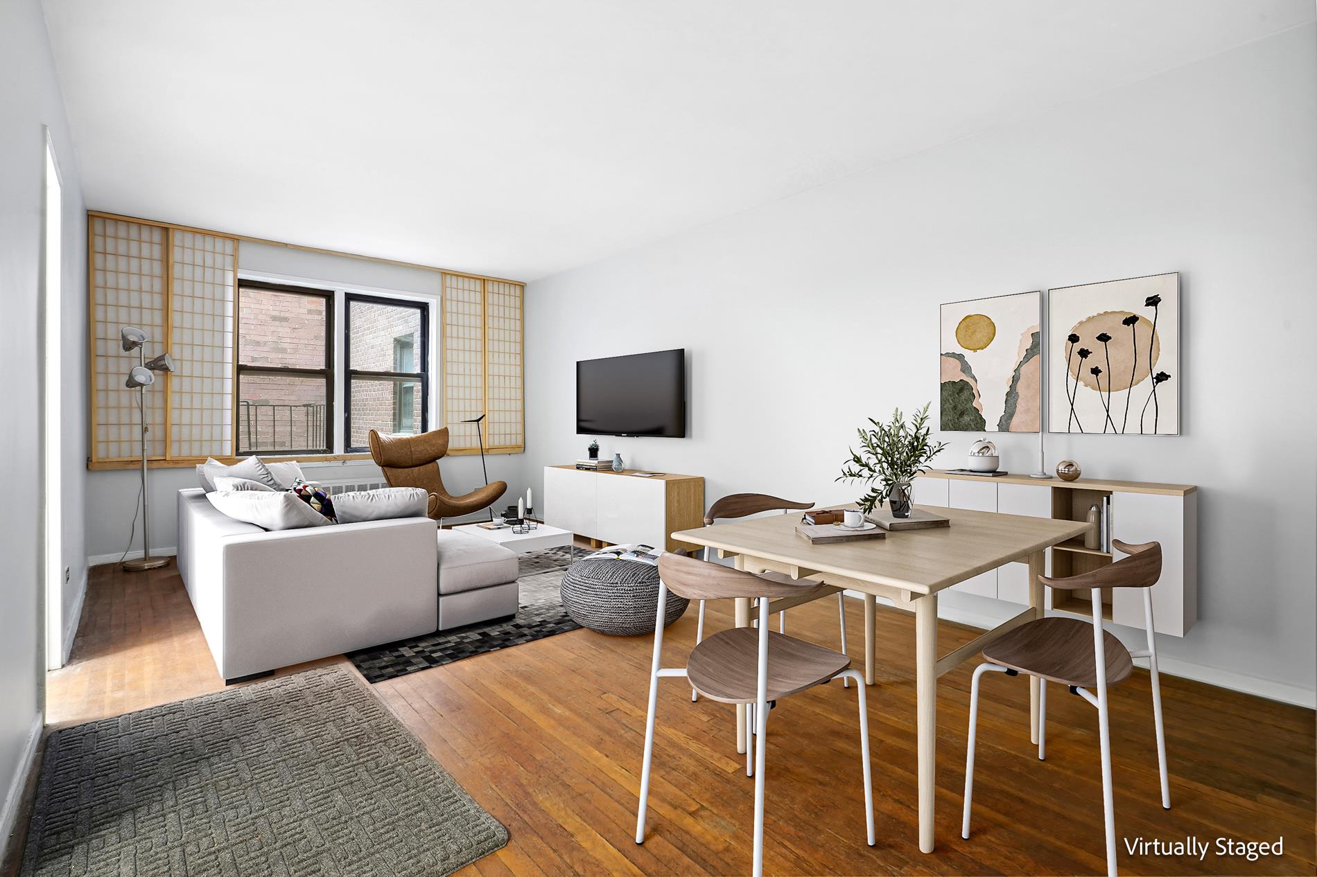 a living room with furniture a flat screen tv and a window