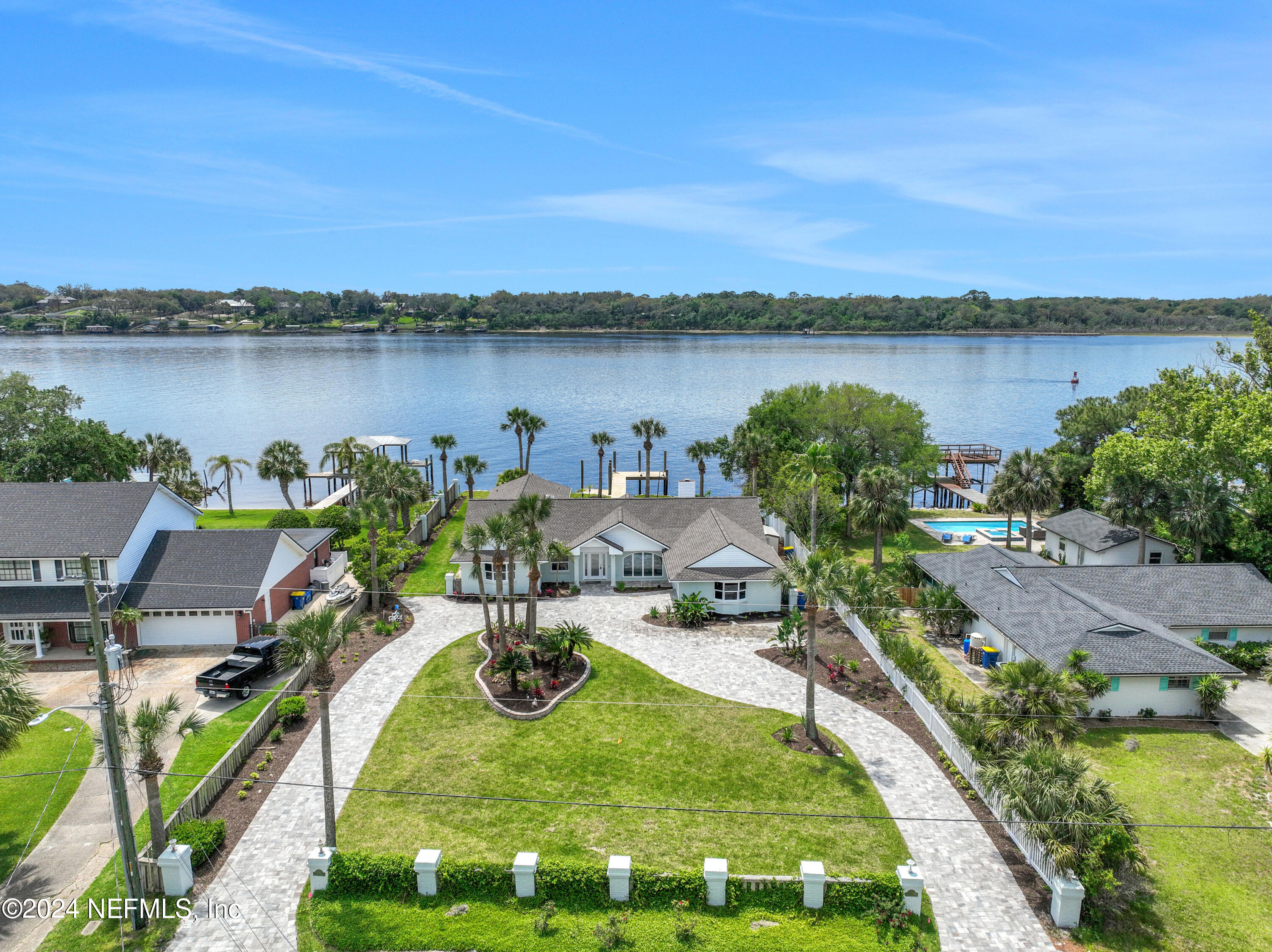 an aerial view of a house with outdoor space and lake view