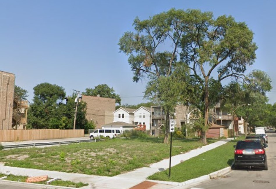 a white house that has a tree in front of it