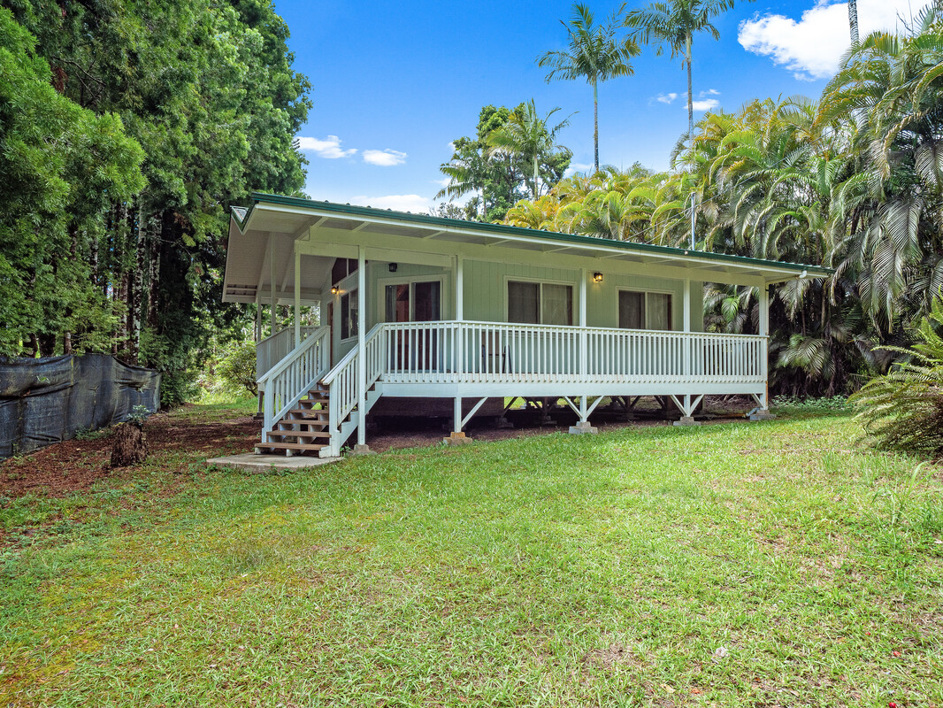 a view of backyard with deck and garden