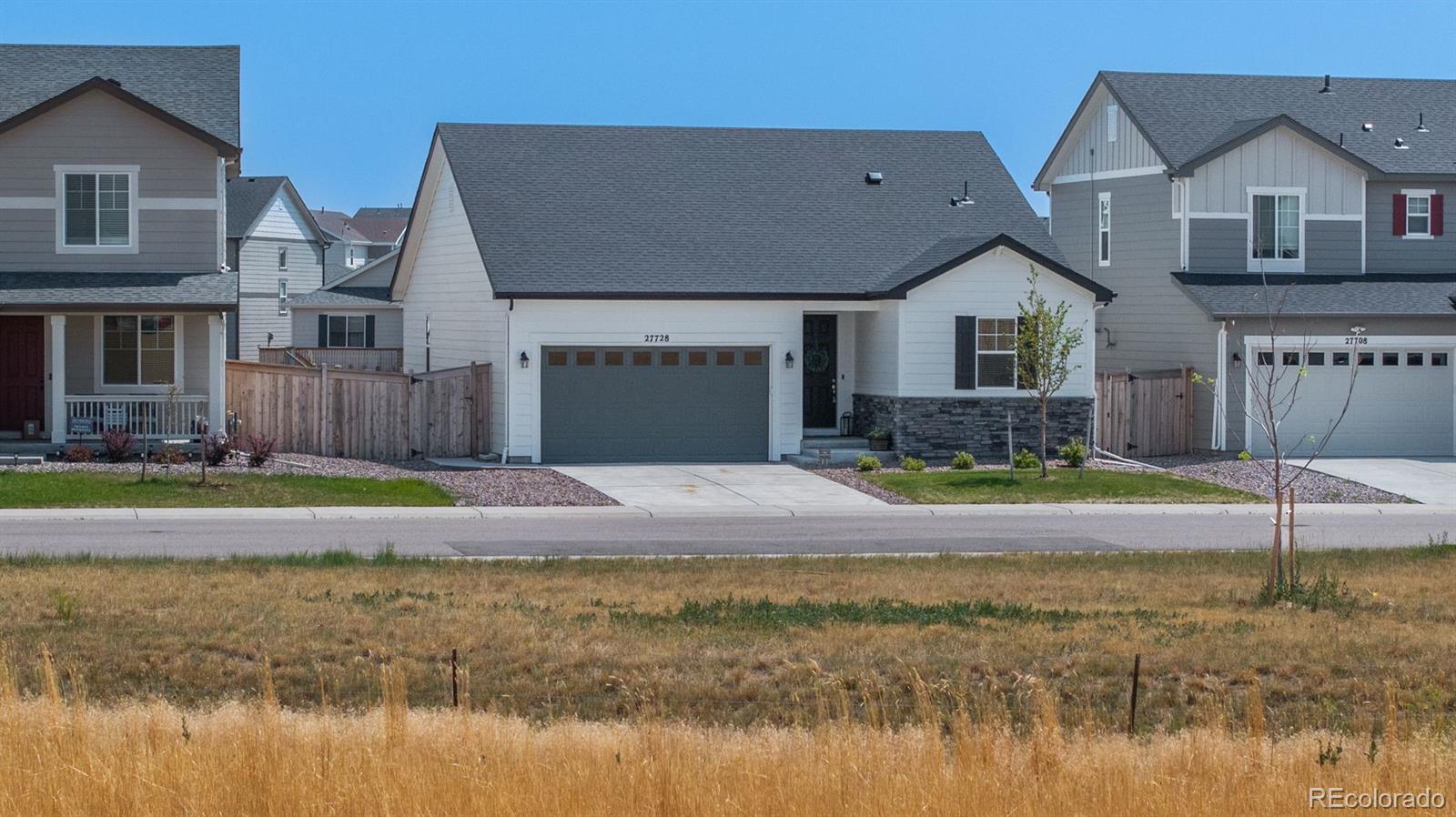 a view of house with a yard and swimming pool