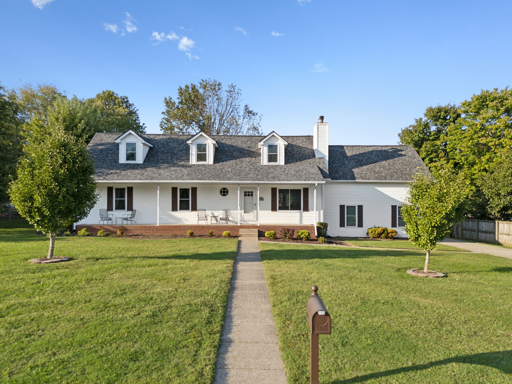 a front view of a house with a garden