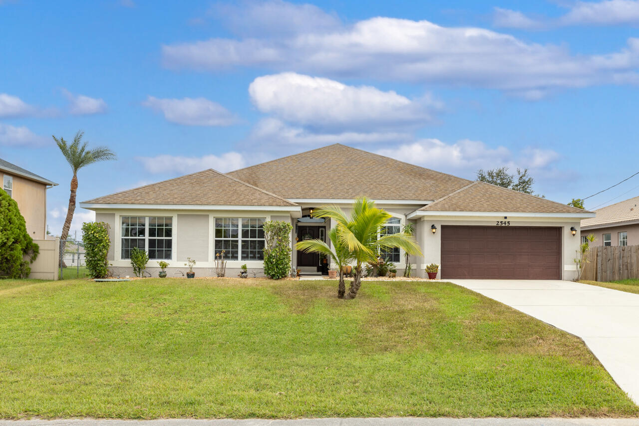 a view of a house with backyard porch and sitting area