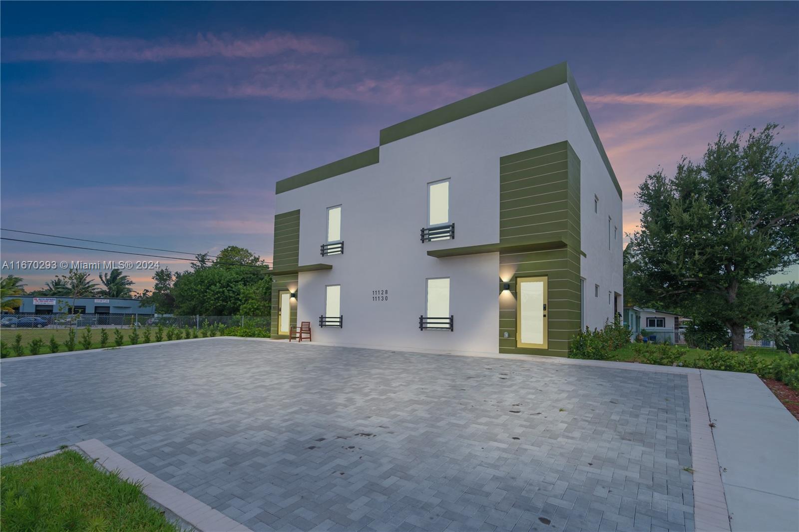 a view of a house with a yard and a garage