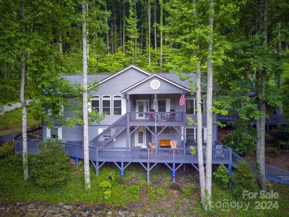 aerial view of a house with a yard balcony and furniture