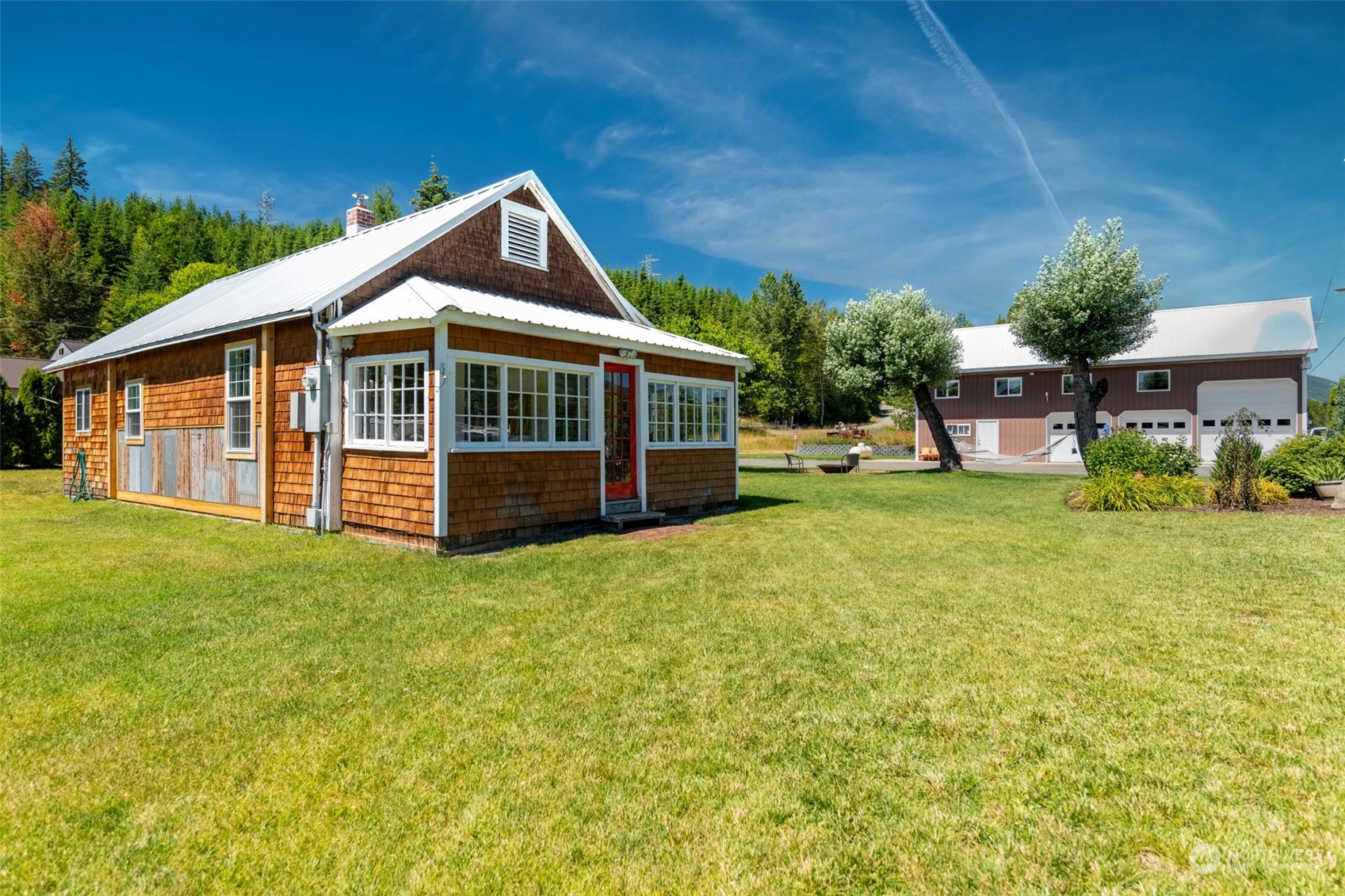 a view of a house with a yard and sitting area