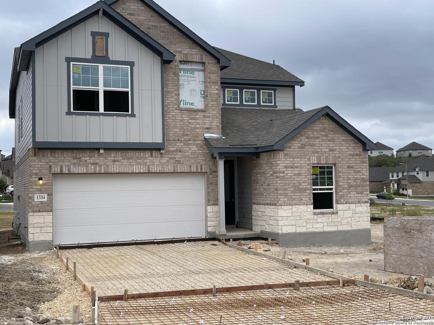 a front view of a house with garage