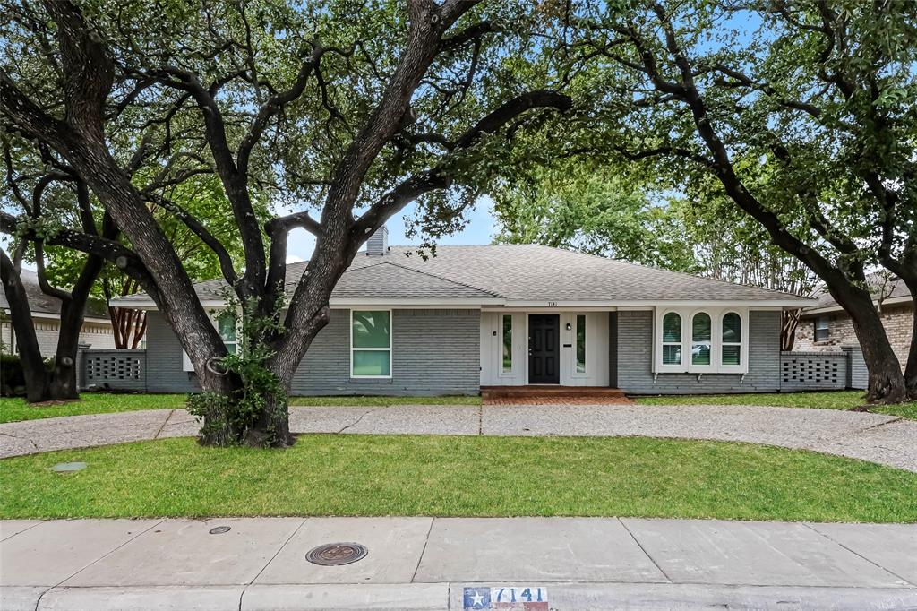 a front view of house with yard and green space