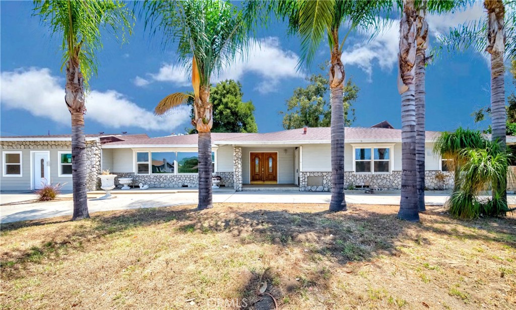 a front view of a house with garden and patio