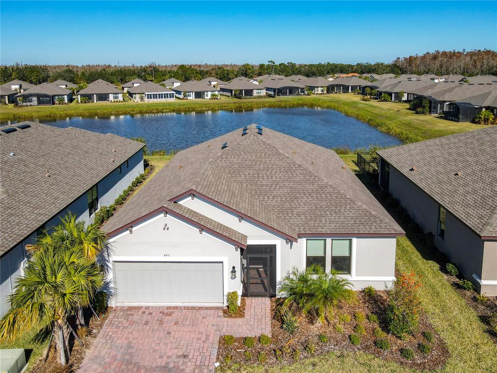 an aerial view of a house with a swimming pool and outdoor seating