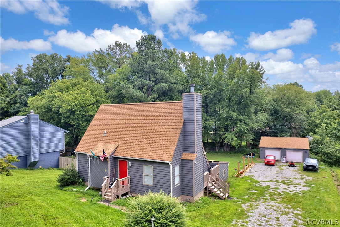 an aerial view of a house with yard