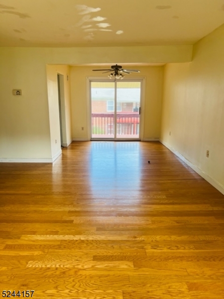 a view of a room with wooden floor and a window