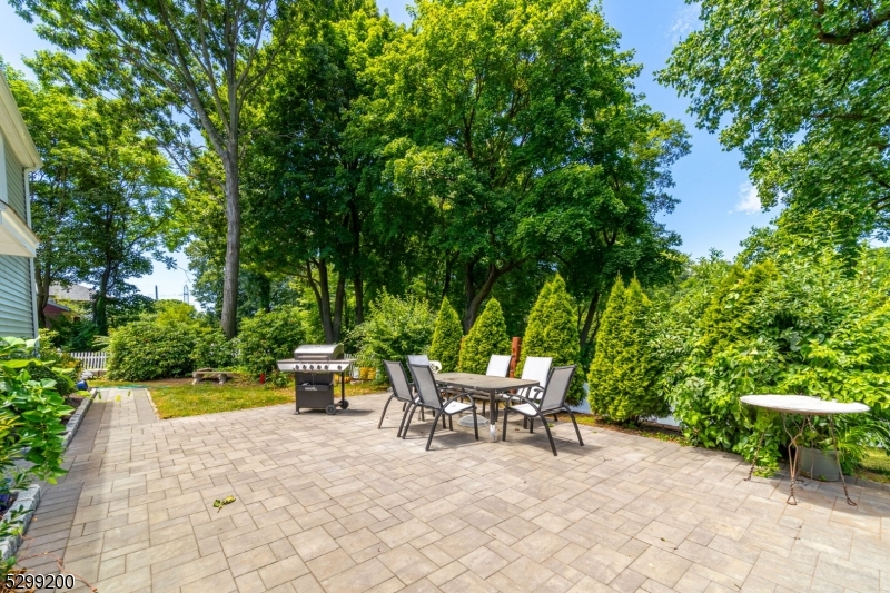 a view of a patio with a table and chairs and potted plants