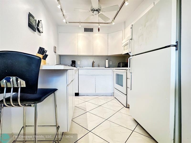 a kitchen with stainless steel appliances a refrigerator sink and cabinets