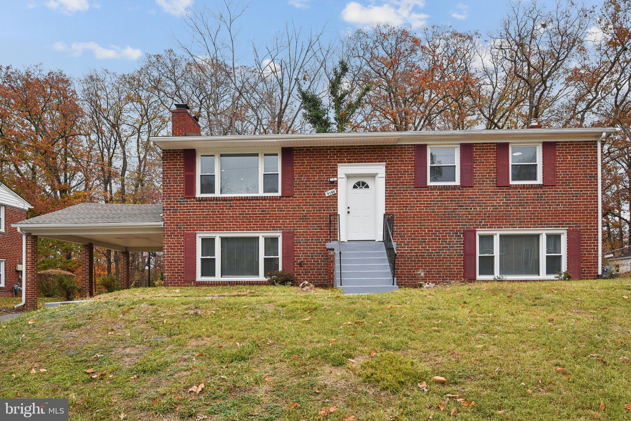 front view of brick house with a yard