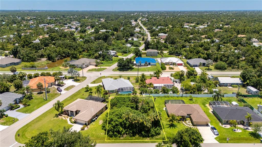 an aerial view of residential houses with outdoor space and swimming pool