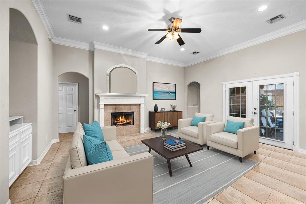 a living room with furniture fireplace and a large window