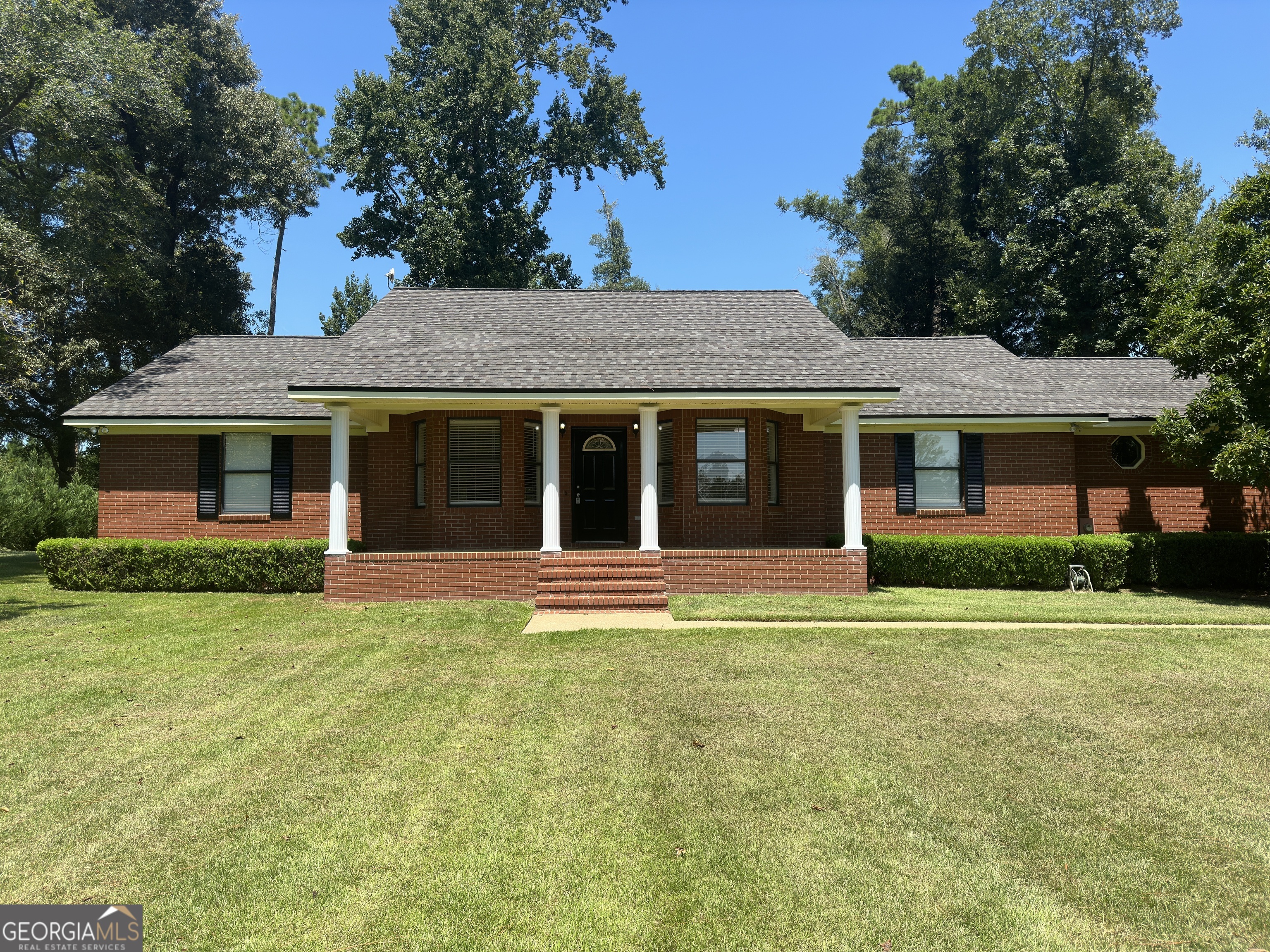 a front view of a house with a garden