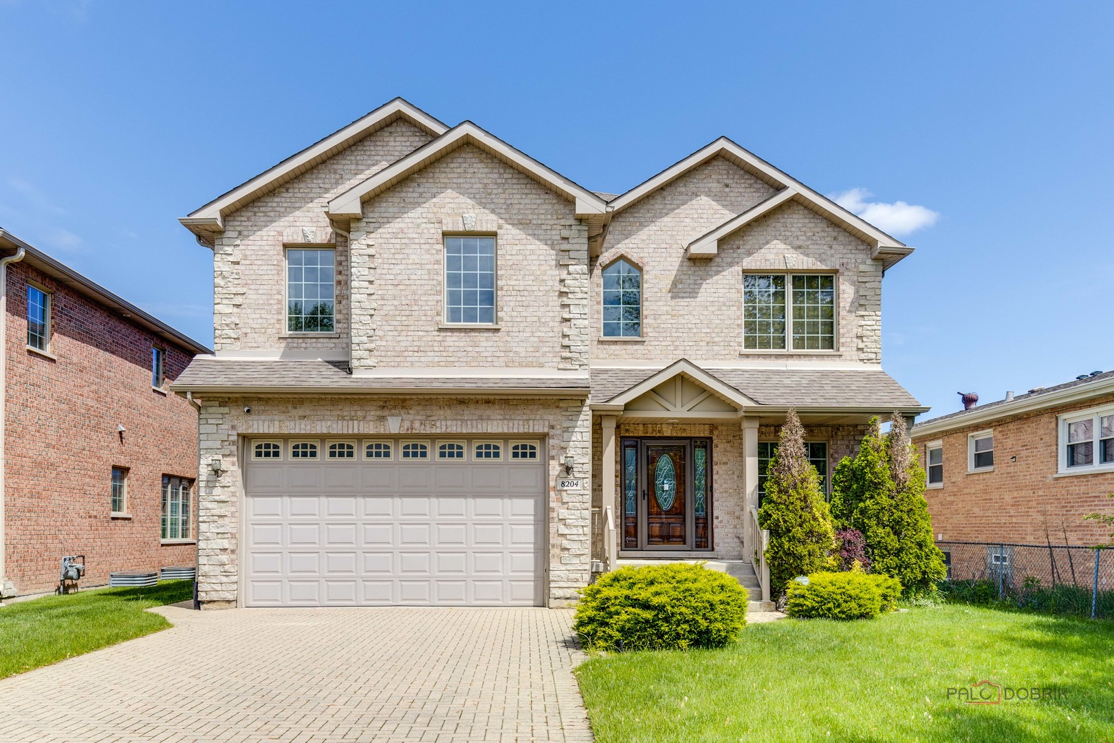 a front view of a house with a yard and garage