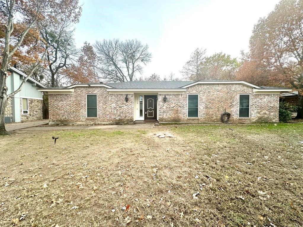 a front view of a house with a garden and yard