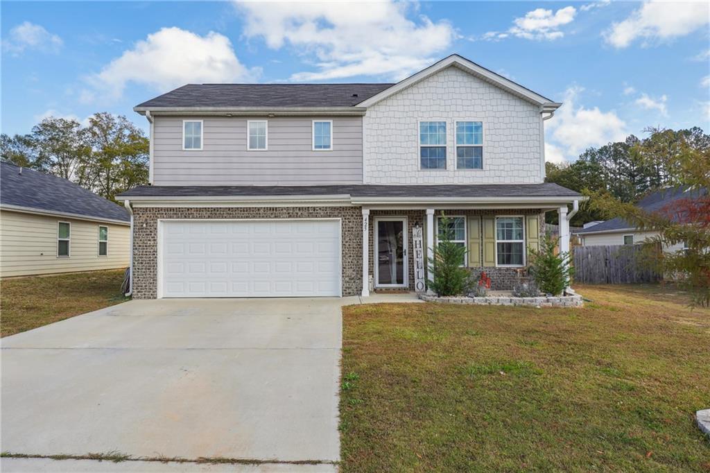 a front view of a house with a yard and garage