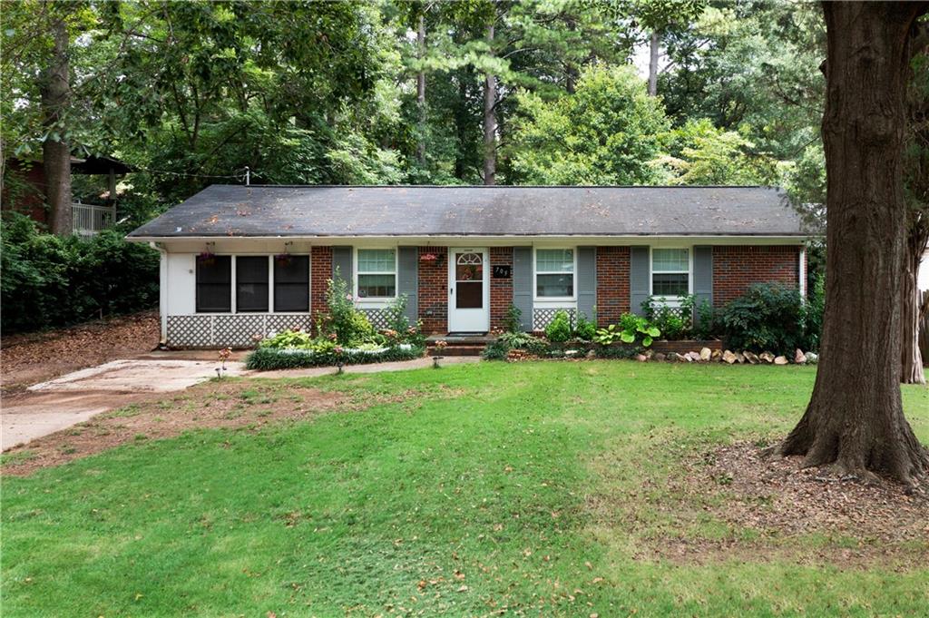 a front view of house with a garden