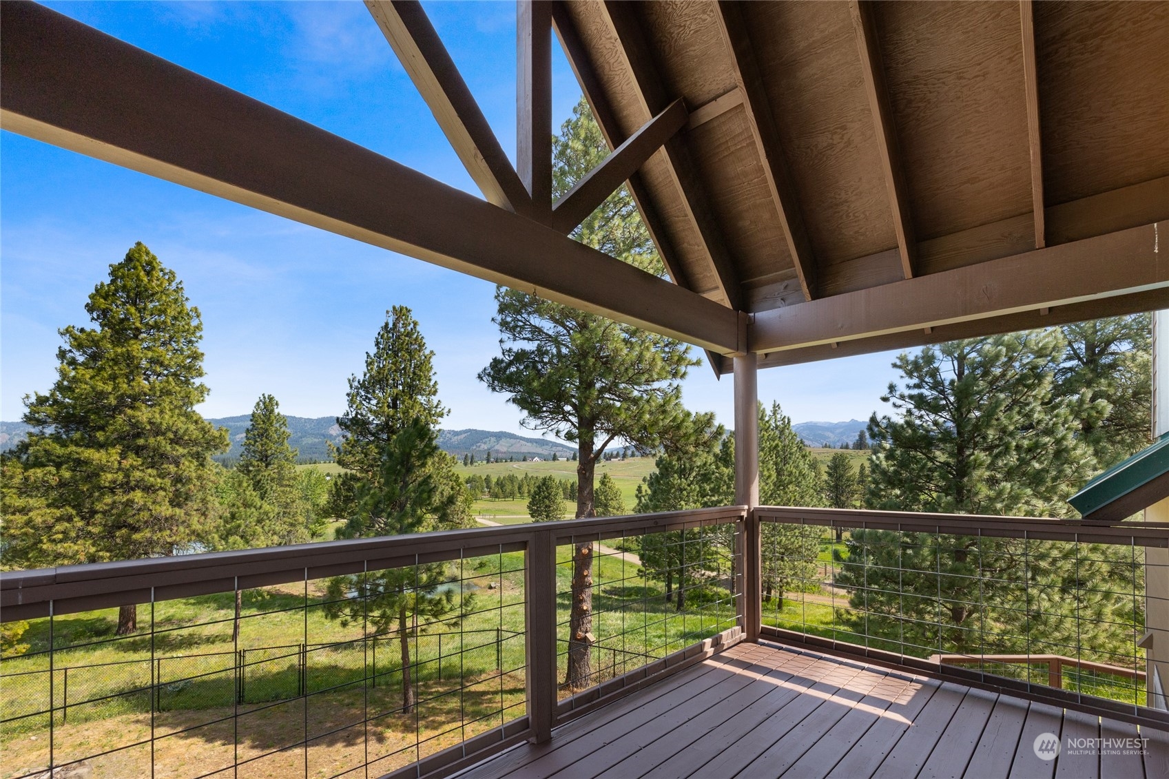 a view of a balcony with wooden floor