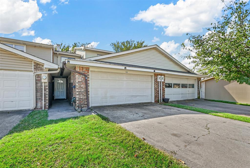 a view of a house with a yard and garage