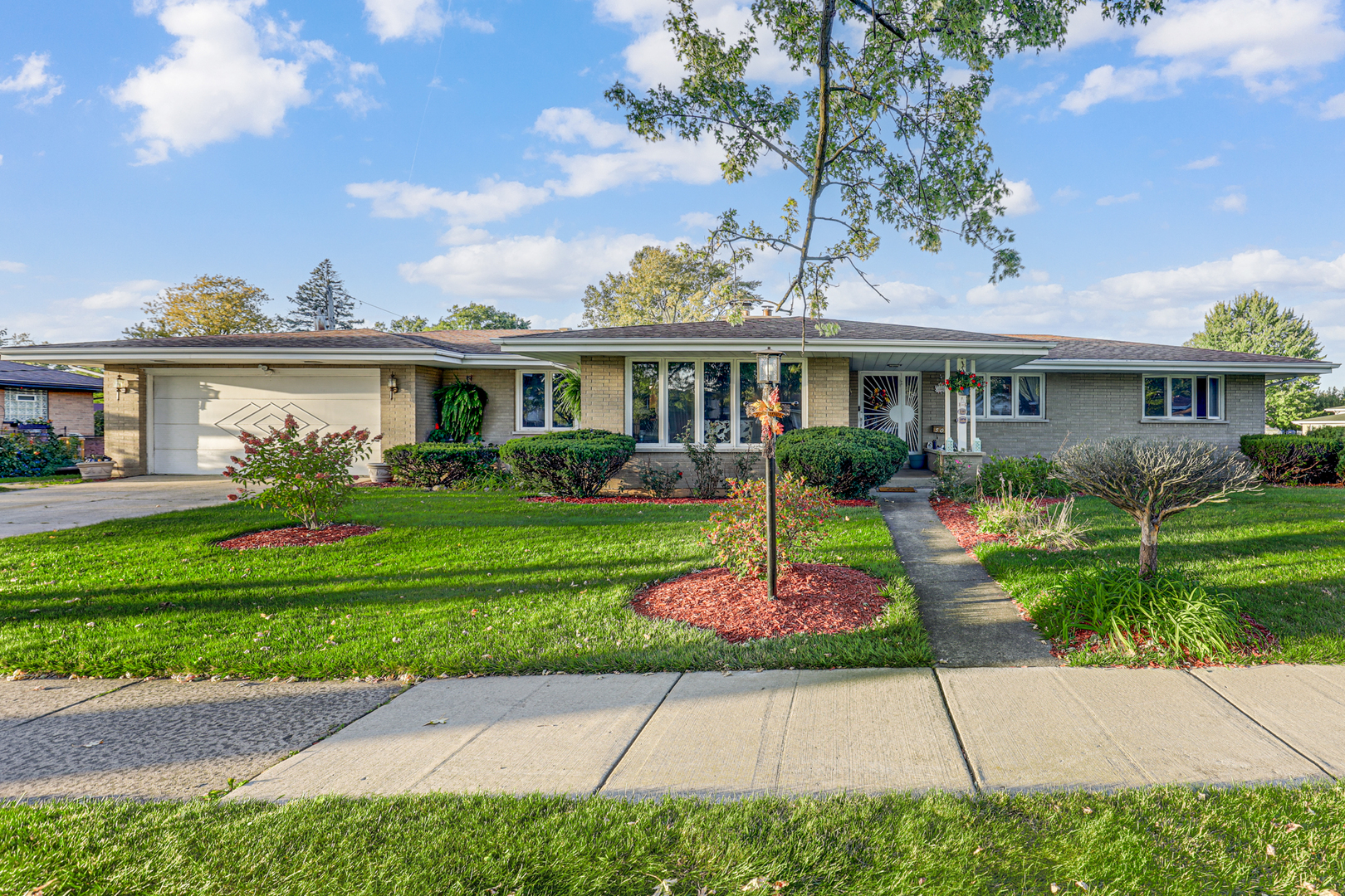 a front view of house with yard and green space