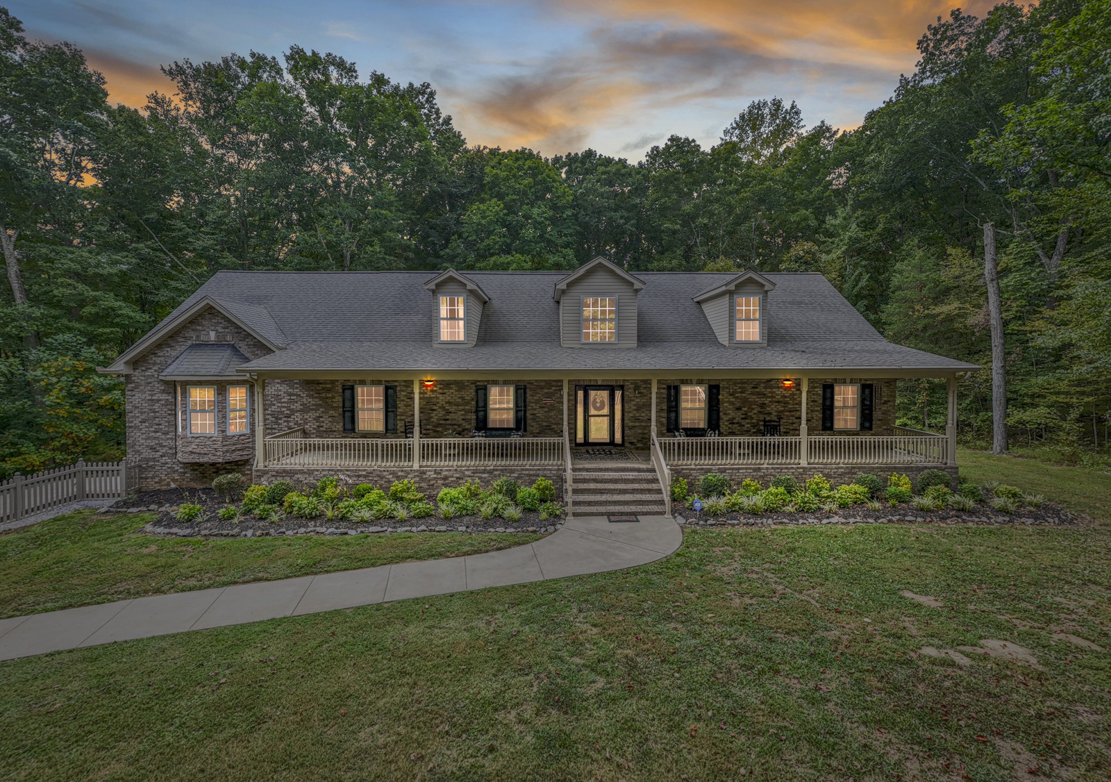 a front view of a house with a garden