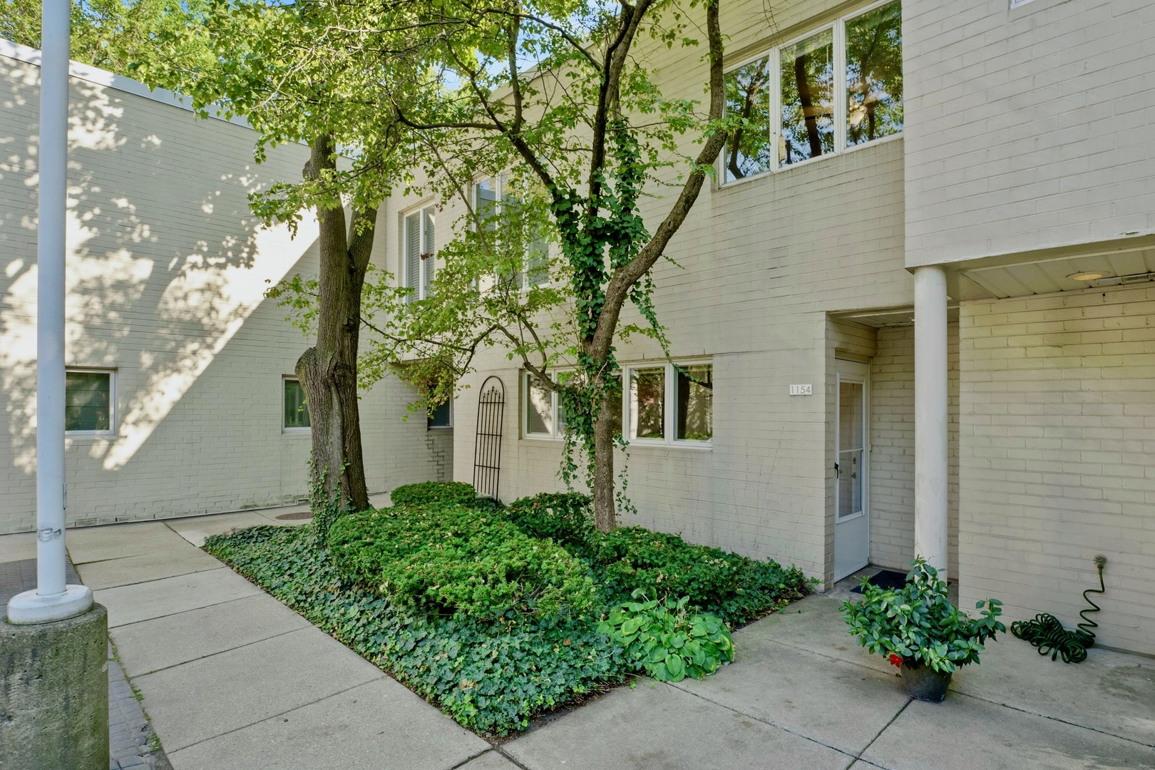 a front view of a house with garden