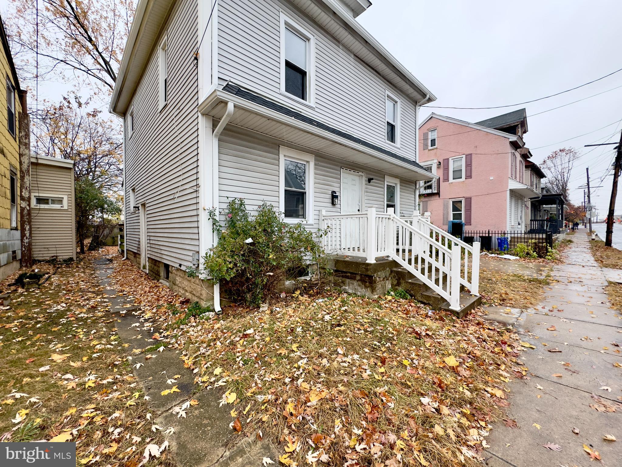 a view of a house with a yard and sitting area