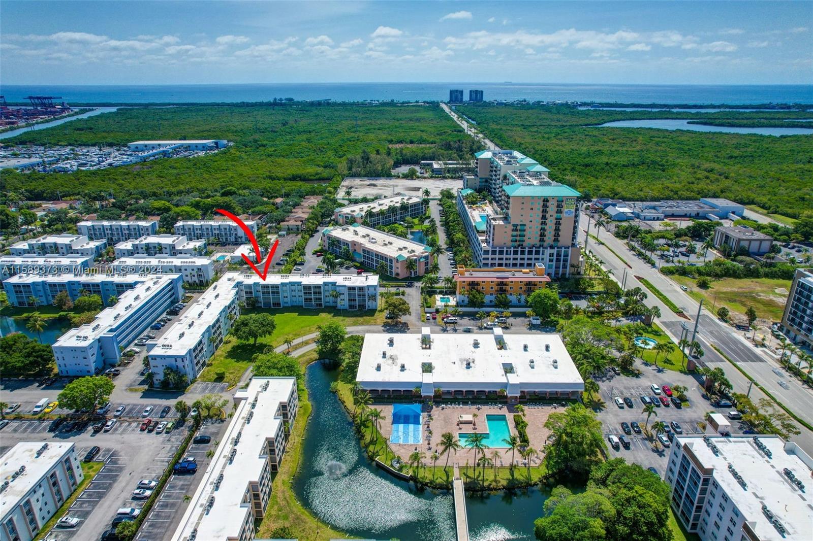 an aerial view of residential houses with outdoor space and swimming pool